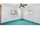 Bright bedroom offers plush green carpet and dual windows providing plenty of natural light at 6349 5Th Street E Cir, Bradenton, FL 34203