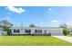 Inviting single-story home with a well-manicured lawn and brick accents at 6349 5Th Street E Cir, Bradenton, FL 34203
