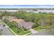 Residential community featuring well-maintained homes, lush landscaping, and a scenic lake in the background at 6617 Nautical Dr, Lakewood Ranch, FL 34202
