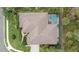 Aerial view of the home, showcasing the roof, lanai and backyard at 6617 Nautical Dr, Lakewood Ranch, FL 34202