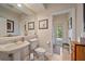 Cozy bathroom with pedestal sink, adjacent toilet, and direct outdoor access at 6617 Nautical Dr, Lakewood Ranch, FL 34202