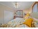 Bright bedroom with hardwood shutters, ceiling fan, closet, and bright floral bedding at 6617 Nautical Dr, Lakewood Ranch, FL 34202
