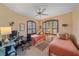 Bedroom featuring twin beds, a desk, office chair, and shuttered windows at 6617 Nautical Dr, Lakewood Ranch, FL 34202