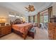 Spacious bedroom features a ceiling fan and a sliding glass door to the outside at 6617 Nautical Dr, Lakewood Ranch, FL 34202
