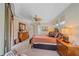 Spacious primary bedroom with ceiling fan, seating, bedside tables, and a large dresser at 6617 Nautical Dr, Lakewood Ranch, FL 34202