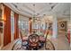 Elegant dining room featuring a chandelier, decorative rug, and views into other living spaces at 6617 Nautical Dr, Lakewood Ranch, FL 34202