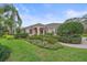 Beautifully landscaped front yard with manicured shrubs and a well-maintained lawn enhances curb appeal at 6617 Nautical Dr, Lakewood Ranch, FL 34202