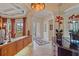 Elegant foyer with decorative lighting, tile flooring, and architectural details leading into dining and living areas at 6617 Nautical Dr, Lakewood Ranch, FL 34202