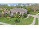 Beautiful single-story home featuring a lush lawn, tropical landscaping, tile roof, and paver driveway at 6617 Nautical Dr, Lakewood Ranch, FL 34202