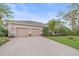 A lovely home showing a two-car garage, manicured lawn and paver driveway at 6617 Nautical Dr, Lakewood Ranch, FL 34202
