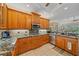 Bright kitchen featuring wood cabinets, granite countertops, and stainless steel appliances at 6617 Nautical Dr, Lakewood Ranch, FL 34202