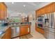 Modern kitchen with stainless steel appliances, wood cabinets, and an open layout at 6617 Nautical Dr, Lakewood Ranch, FL 34202