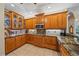 Gourmet kitchen with granite countertops, stainless steel appliances, custom cabinetry, and open layout at 6617 Nautical Dr, Lakewood Ranch, FL 34202
