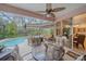 This screened patio includes ample seating, ceiling fan, and views of the pool, ideal for outdoor dining at 6617 Nautical Dr, Lakewood Ranch, FL 34202
