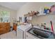 Spacious laundry room with modern washer and dryer units and plenty of storage space at 6617 Nautical Dr, Lakewood Ranch, FL 34202