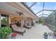 Spacious outdoor patio featuring lounge chairs, ceiling fan, and access to the home's interior at 6617 Nautical Dr, Lakewood Ranch, FL 34202
