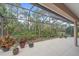 Large screened patio with lush landscaping offers a serene outdoor experience and privacy at 6617 Nautical Dr, Lakewood Ranch, FL 34202