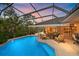 Twilight view of a screened pool area with lounge seating, creating an inviting outdoor retreat at 6617 Nautical Dr, Lakewood Ranch, FL 34202