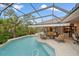 Screened pool with lounge chairs and outdoor dining area, perfect for relaxing and entertaining at 6617 Nautical Dr, Lakewood Ranch, FL 34202