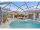 Spacious pool and patio area featuring comfortable outdoor seating, a retractable awning, and screened enclosure at 6617 Nautical Dr, Lakewood Ranch, FL 34202