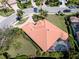 Aerial view of a home showcasing the tile roof, screened-in pool, and well-manicured landscaping at 7141 Whitemarsh Cir, Lakewood Ranch, FL 34202