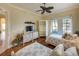 Bedroom with a coastal aesthetic showcasing matching twin beds, wooden floors, and large windows at 7141 Whitemarsh Cir, Lakewood Ranch, FL 34202