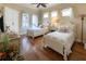 Bright bedroom featuring hardwood floors, two twin beds and a ceiling fan at 7141 Whitemarsh Cir, Lakewood Ranch, FL 34202