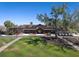Clubhouse at Legacy Golf Club with covered entrance, mature trees, and golf cart parking at 7141 Whitemarsh Cir, Lakewood Ranch, FL 34202
