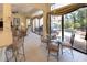 Bright dining area features a glass table, stylish chairs, and direct access to the outdoor pool and patio at 7141 Whitemarsh Cir, Lakewood Ranch, FL 34202