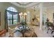 Dining area showcasing a chandelier, round table set, and large window with natural light, creating a comfortable space at 7141 Whitemarsh Cir, Lakewood Ranch, FL 34202