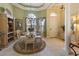 Lovely dining room with elegant chandelier, round table set, and neutral decor, perfect for formal entertaining at 7141 Whitemarsh Cir, Lakewood Ranch, FL 34202