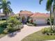Beautiful single-story home with well-manicured landscaping and a brick driveway, perfect for enjoying the Florida lifestyle at 7141 Whitemarsh Cir, Lakewood Ranch, FL 34202