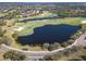 Aerial view of a lush golf course community with scenic lakes, sand traps, and well-manicured green fairways at 7141 Whitemarsh Cir, Lakewood Ranch, FL 34202