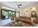 Open-concept living area featuring a leather sofa, archways, and seamless flow to dining and kitchen, perfect for entertaining at 7141 Whitemarsh Cir, Lakewood Ranch, FL 34202