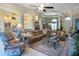 Spacious living room features a plush sectional sofa, arched entryways, and elegant decor, creating a cozy ambiance at 7141 Whitemarsh Cir, Lakewood Ranch, FL 34202