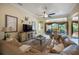Bright living room boasts a large sectional sofa, neutral walls, and views of the outdoor lanai, offering a comfortable retreat at 7141 Whitemarsh Cir, Lakewood Ranch, FL 34202