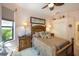 Comfortable main bedroom features stylish wood furniture and a decorative ceiling fan at 7141 Whitemarsh Cir, Lakewood Ranch, FL 34202
