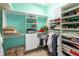 Organized walk-in closet with custom shelving, hanging rods, and storage for clothes, shoes, and accessories at 7141 Whitemarsh Cir, Lakewood Ranch, FL 34202