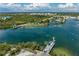Tranquil view of the ferry and waterfront surrounded by beautiful blue skies and landscaping at 7490 Palm Island Dr # 2324, Placida, FL 33946