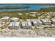 Scenic aerial view highlighting beachfront condos with private beach access near a serene bay at 7490 Palm Island Dr # 2324, Placida, FL 33946