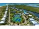 Expansive aerial view featuring tennis courts, swimming pool, marina, and lush greenery at 7490 Palm Island Dr # 2324, Placida, FL 33946