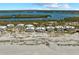 Wide aerial perspective featuring beachfront condos and the beautiful bay on a sunny day at 7490 Palm Island Dr # 2324, Placida, FL 33946