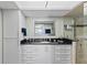Bright bathroom featuring a modern vanity with a sleek black countertop at 7490 Palm Island Dr # 2324, Placida, FL 33946