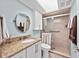 Well-lit bathroom with tan granite countertop, under-mount sink, and tiled shower at 7490 Palm Island Dr # 2324, Placida, FL 33946