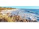 Beautiful ocean view from the rocks on the beach with blue waves crashing on the shore in this area with no lifeguard at 7490 Palm Island Dr # 2324, Placida, FL 33946