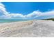 Expansive sandy beach with clear blue water and a bright blue sky, perfect for a relaxing day by the ocean at 7490 Palm Island Dr # 2324, Placida, FL 33946