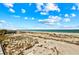 Panoramic beach view from a balcony, showcasing the vast expanse of sand and sea at 7490 Palm Island Dr # 2324, Placida, FL 33946