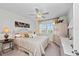 Cozy bedroom with a ceiling fan, bright windows, and light, neutral decor at 7490 Palm Island Dr # 2324, Placida, FL 33946