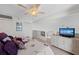 Cozy bedroom with a ceiling fan, tv, white dressers, and multiple closets offering ample storage space at 7490 Palm Island Dr # 2324, Placida, FL 33946