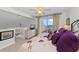 Bright bedroom featuring a ceiling fan and sliding glass doors to a private outdoor seating area with ocean views at 7490 Palm Island Dr # 2324, Placida, FL 33946